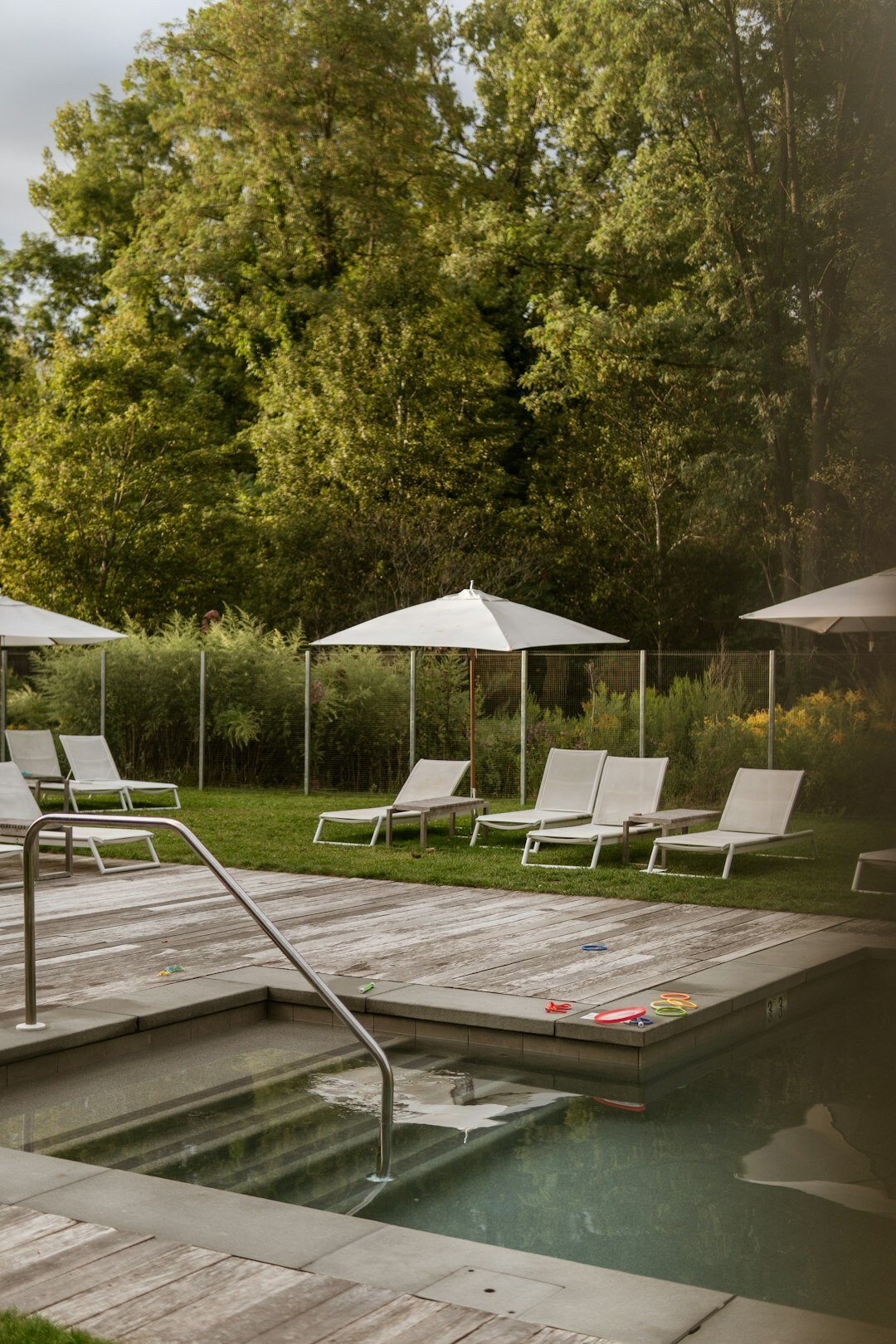 Outdoor thermal spa pool surrounded by loungers