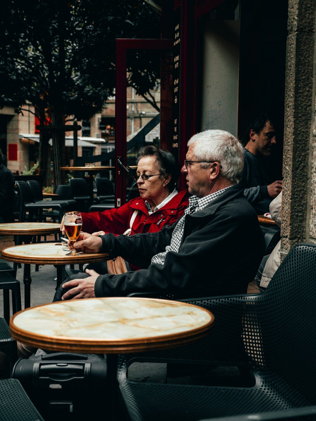 Senior couple enjoying coffee at a partner cafe with a discount card